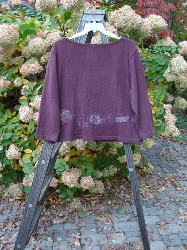 Barclay Textured Cotton Knit Crop Box Sweater in Deep Rose, displayed on a wooden rack, showcasing its wide neckline, button closure, and cozy sleeves. This vintage piece is part of the Fall Collection.