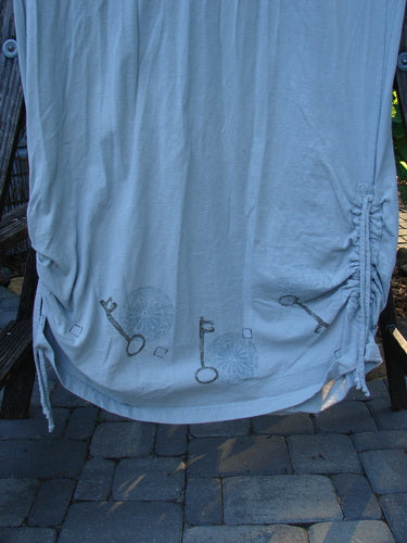 1999 Starlight Dress Celtic Garden Blue Horizon Size 0, featuring a drawing on a white sheet, with a softer rolled double layered neckline, sleeve lacings, and two side vertical drawcords.