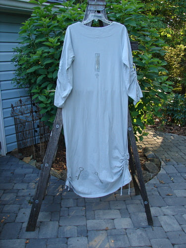 1999 Starlight Dress Celtic Garden Blue Horizon Size 0 displayed on a wooden rack, featuring rolled double-layered neckline, sleeve lacings, and vertical side drawcords, showcasing superior Celtic Garden paint.