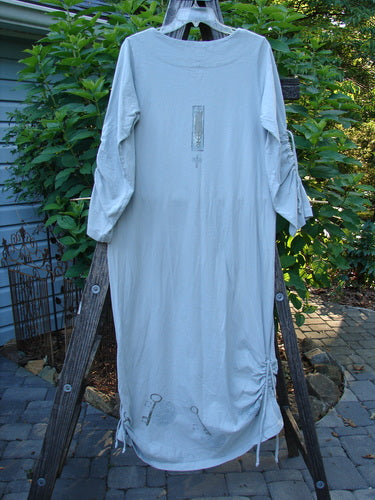 1999 Starlight Dress Celtic Garden Blue Horizon Size 0 displayed on a wooden ladder, showcasing its superior Celtic Garden paint, softer rolled double-layered neckline, and lovely sleeve lacings.