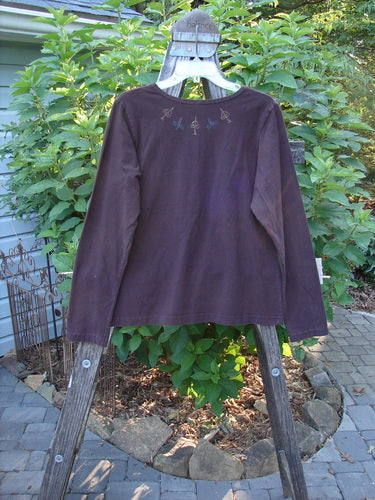 1999 Cotton Lycra Long Sleeved Layering Top Necklace Deep Burgundy Size 2 displayed on a wooden clothes rack, showcasing its full-length sleeves and stretchy fabric.