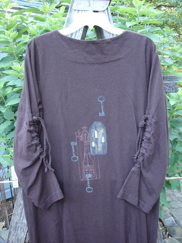 1999 Starlight Dress Celtic Key Deep Burgundy Size 0: A long-sleeved shirt featuring intricate Celtic key artwork, softer double-layered neckline, sleeve lacings, and vertical drawcord accents on substantial organic cotton fabric.