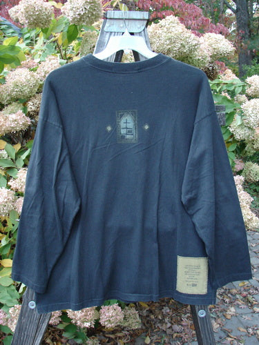 1997 Long Sleeved Tee Stone Door Cast Iron Size 1 displayed on a swinger, featuring drop shoulders, wider ribbed neckline, cozy longer sleeves, and a square box shape made from mid-weight organic cotton.