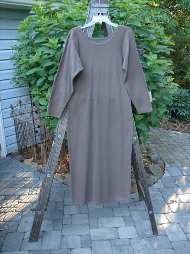 1991 Rib Thermal The Skinny Dress Unpainted Nut Brown Altered OSFA displayed on a wooden rack, showcasing its long sleeves, rounded neckline, and straight linear shape.