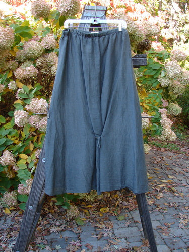 2000 Hemp Silk Continuous Garden Duo Domino Size 2: A pair of pants on a wooden stand, a blue skirt on a wooden rack, and a close-up of a blue skirt