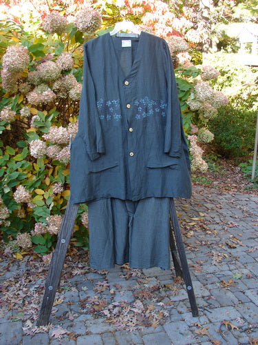 2000 Hemp Silk Continuous Garden Duo Domino Size 2: A clothes rack with a blue shirt featuring a flower design and a close-up of a black dress.