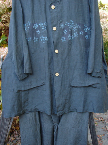2000 Hemp Silk Continuous Garden Duo Domino Size 2: A blue shirt with flowers on it, featuring a deep V neckline, A-line shape, front drop pockets, and a drawcord backline. The matching tie skirt has a front tie and elastic waistline.