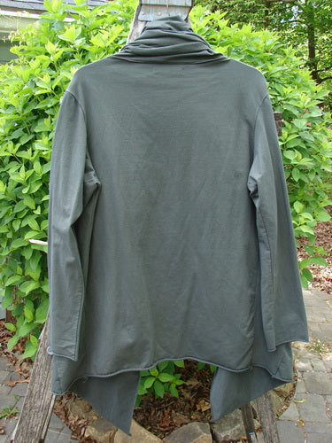 Barclay Cotton Lycra Gather Collar Open Front Jacket Unpainted Forest Size 1, draping gracefully on a wooden post, showcasing its flowing open front, unique drawcord neckline, and paneled pockets, embodying vintage Blue Fish style.