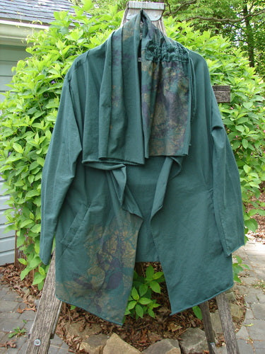 Barclay Cotton Lycra Gather Collar Open Front Jacket draped on a ladder, showcasing its elegant drape and distinctive neckline, accented by a matching green scarf, embodying Bluefishfinder.com's vintage style.