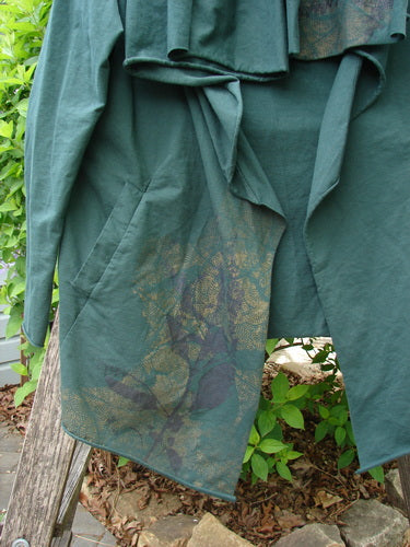 Barclay Cotton Lycra Gather Collar Open Front Jacket Golden Forest Size 0 draped on a ladder, showcasing its waterfall-style front, angled pocket, and subtle botanical print in muted tones.