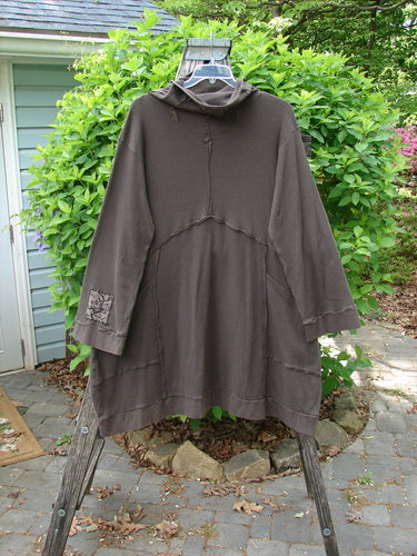 Barclay Patched Thermal Cowl Neck Reverse Stitch Pocket Pullover in Bark, displayed on a hanger outdoors, showcases its cozy cowl neck, unique stitch pattern, and flowing silhouette, ideal for winter wear.