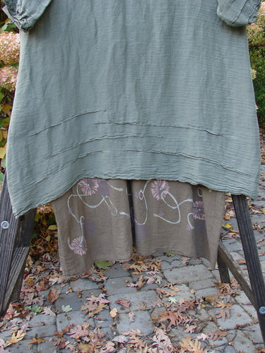 Barclay Hemp Silk Triangular Two Tier Dress Garden Soft Moss Rock Size 2 displayed on a rack, featuring a contrasting V-shaped neckline, pinched accents, and varying hemline.
