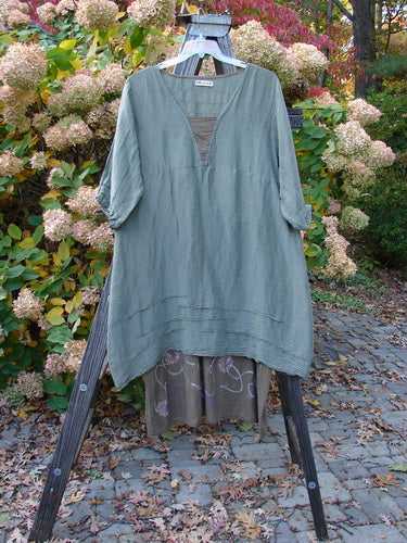 Barclay Hemp Silk Triangular Two Tier Dress; garden-themed, with contrasting V neckline and pinched accents, displayed on a rack.