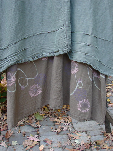 Barclay Hemp Silk Triangular Two Tier Dress Garden Soft Moss Rock Size 2: Close-up of fabric details, highlighting the pinched accents, tiered construction, and painted garden theme on the lower skirt.