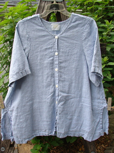 1999 Handkerchief Linen Camp Shirt Unpainted Stream Size 1 displayed on a clothes rack, showcasing its A-line shape, tiny vented sides, and signature patch with coordinating buttons.