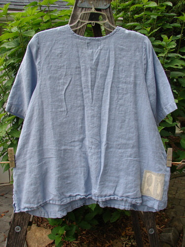 1999 Handkerchief Linen Camp Shirt Unpainted Stream Size 1 on a clothesline, showcasing its A-line shape, tiny vented sides, and small original buttons, emphasizing its breezy, lightweight fabric.