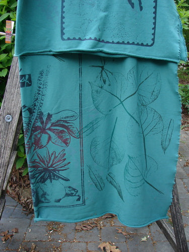 Barclay Heavy Weight Organic Sweatshirt Blanket Pony Garden Emerald OSFA draped on a wooden ladder, displaying botanical motifs and raw unfinished edges, embodying BlueFishFinder's vintage, creative clothing ethos.
