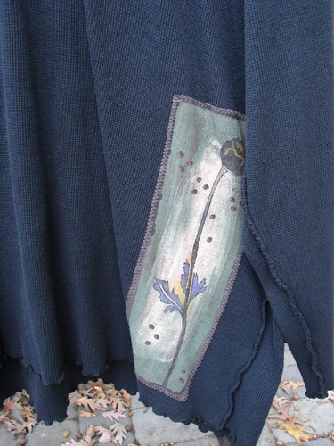 Close-up of Barclay Patched Thermal Reverse Stitch Big Square Tunic in Black, featuring exterior center seams, drop shoulder seams, and painted nature-themed patches.