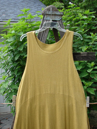 2000 Cotton Hemp Libby Jumper Falling Leaf Gold Altered Size 1 displayed on a mannequin, showcasing its sophisticated drape, scooped waistline, and bubbled shape with detailed fall leaf pattern.