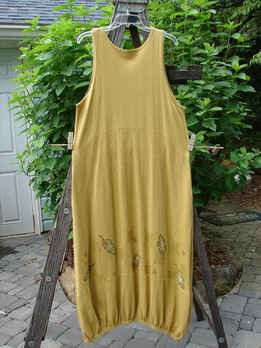 2000 Cotton Hemp Libby Jumper Falling Leaf Gold Altered Size 1, displayed on a wooden ladder, showcasing its sophisticated drape, side pockets, and detailed fall leaf theme paint.
