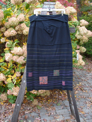 Barclay Patched Thermal Fold Over Pencil Panel Skirt Grid Stripe Black Size 2, displayed on a rack, showcasing its fold-over waistline, horizontal stitchery, and tiny patches along the hem, made from organic cotton.
