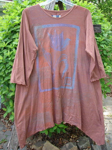 Barclay Three Quarter Sleeve Color Wheel Tunic Tulip Gourd Size 0, featuring a scoop neckline, asymmetrical hem, and abstract blue motif, hangs outdoors, showcasing vintage-inspired organic cotton elegance.