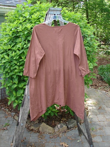Barclay Three Quarter Sleeve Color Wheel Tunic Tulip Gourd Size 0 on hanger, showcasing a loose fit with a handkerchief hem, lettuce-edged ¾ sleeves, and tulip garden theme, displayed on a wooden ladder.