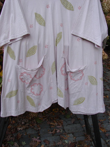 Barclay Double Draw Center Vent Tunic Top Leaf Pink Tile Size 2 with pink floral and leaf patterns, rounded neckline, wide sleeves, exterior pockets, and a generous flouncy lower skirt.