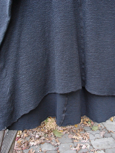 Barclay Crepe Hi Low Top Unpainted Black Size 2, featuring a thick textured cotton crepe fabric, wider rounded neckline, vertical center seam, upward curved front hemline, and long sleeves.