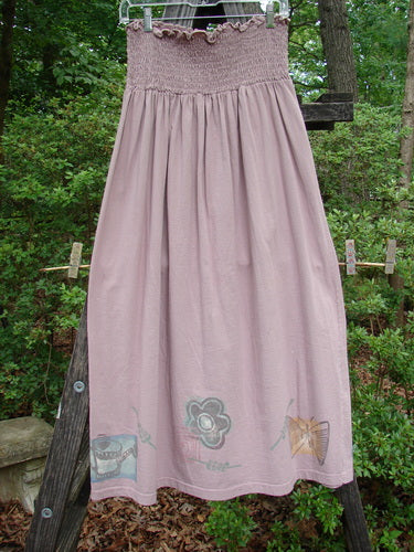 1995 Smocked Skirt Garden Patio Rose Size 2 displayed on a wooden ladder, showcasing its full flowy length and intricate smocking details.