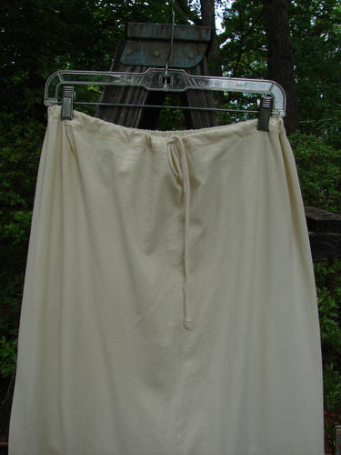 2001 Wishpocket Skirt Circle Rows Natural Size 1 displayed on a clothes line, showcasing its lightweight organic cotton fabric, front drawstring waist, and two oversized lower pockets.