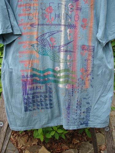 Barclay Short Sleeved Straight Tee BF Promo Light Tealen Size 0, featuring bold BLUE FISH CLOTHING text and a colorful bird design with abstract graphics, illustrating Bluefishfinder.com's expressive vintage style.