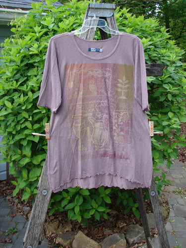 Barclay Slub Modal Three Quarter Sleeved Cafe Tee Merry Farm Mallow Size 0, displayed on a wooden ladder, features a toucan and penguins graphic, rounded neckline, and three-quarter sleeves with curly edges.