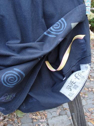 1992 Little Storma Dress Garden Bug Black Small OSFA featuring yellow silk ribbon and intricate garden bug motifs, displayed on blue fabric with tapering lower and rounded neckline.