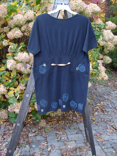 1992 Little Storma Dress Garden Bug Black Small OSFA, featuring a blue shirt on a wooden rack with a tapering lower, deep rounded neckline, and superior garden bug-themed paint.