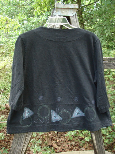 2000 4 Corners Jacket Travel Stone Black Size 1 - organic cotton, medium weight, cropped, flared shape, floral buttons, double-paneled hem, A-line swinging shape with continuous leaf-themed paint.