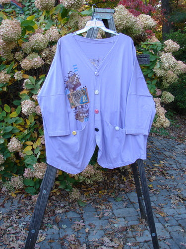 1997 Day Jacket Silly Pup Freesia Size 3 displayed on a rack, featuring long dolman sleeves, V neckline, and drop shoulders, with vintage buttons and front drop pockets.