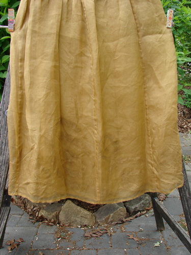 2000 Silk Organza Aios Dana Skirt Celtic Wind Bone Size 0 hangs outdoors, showcasing its crinkled texture and graceful flare, clipped to a ladder, embodying Bluefishfinder.com's vintage elegance.