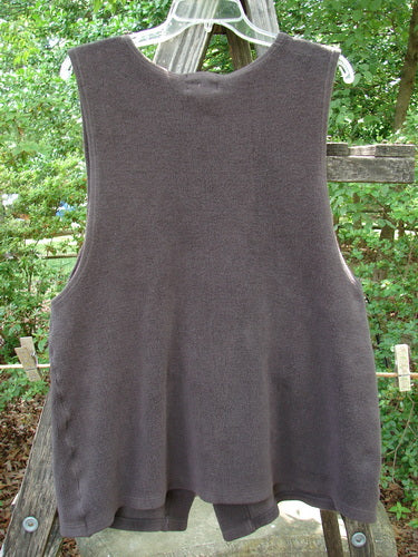 2000 Patched Celtic Moss Global Vest Brum Size 0 hanging on a clothesline, showcasing its V neckline, 3 rubberized buttons, deep arm openings, and signature front lower patch.