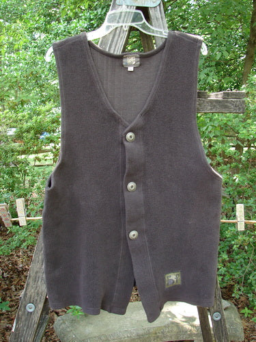 2000 Patched Celtic Moss Global Vest Brum Size 0, displayed on a clothes rack, features 3 buttons, a V neckline, deep arm openings, a vented front, and a blue fish signature patch.