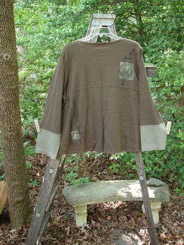 2000 Cotton Hemp Philos Jacket Biology Bark Size 0 displayed on a wooden ladder, showcasing its scooped hemline, sectional horizontal panels, contrasting sleeves, and two lower pockets.