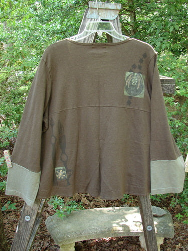 2000 Cotton Hemp Philos Jacket Biology Bark Size 0, featuring contrasting sleeves, sectional horizontal panels, two lower pockets, gently rounded neckline, and a rear flounce, displayed on a swinger.