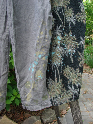 Barclay Linen Pucker Accent 4 Square Pant Tropical Black Grey Size 0 draped on a chair in a garden, featuring abstract palm prints and playful paint spots, highlighting its unique design and drape.