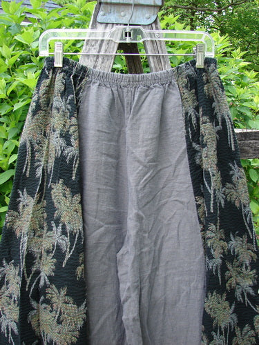 Barclay Linen Pucker Accent 4 Square Pant Tropical Black Grey Size 0: A long skirt featuring a gray center and black textured side panels with a floral motif, displayed on a clear hanger.