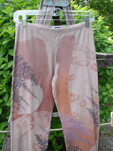 Barclay Cotton Lycra Side Gather Legging Forest Moon Oriel Size 0, displayed on a hanger, features nature-inspired prints and drawcord accents, with a rustic ladder and garden backdrop.