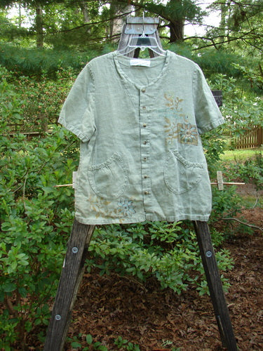 1998 Botanicals Robin's Top Daisy Elm Size 0, displayed on a wooden swinger, showcasing its A-line shape, dual front elastic pockets, and seven tiny buttons, exemplifying vintage Blue Fish Clothing.