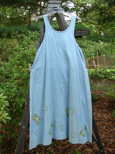 2000 Strappy Jumper Leaf Path Blue Jet Size 1 on display outdoors, highlighting its A-line flared shape, pearl buttons, and leaf path theme hemline.