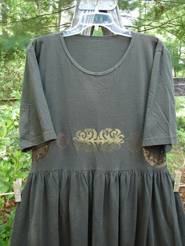 1992 Short Sleeved Simple Dress Metallic Black Sand Altered Size 1 displayed on a hanger, featuring a semi-dropped waistline, full draping lower, and Blue Fish patch.
