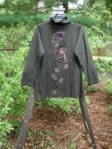1994 Long Sleeved Vented Turtleneck Top Fan Edo Black Altered Size 1 displayed on a hanger outdoors, featuring drop shoulders, vented sides, and a looser turtleneck design.