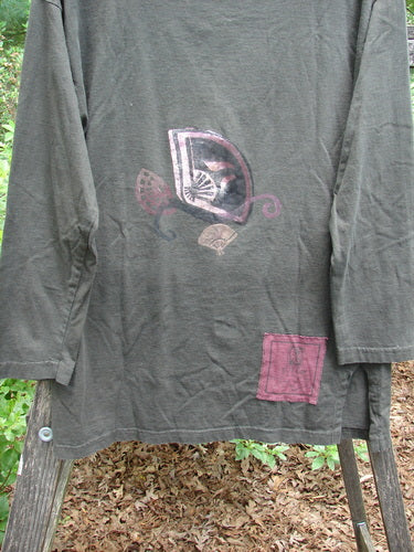 1994 Long Sleeved Vented Turtleneck Top Fan Edo Black Altered Size 1 displayed on a wooden rack, highlighting its drop shoulders and straighter longer shape, with visible signature blue fish patch.